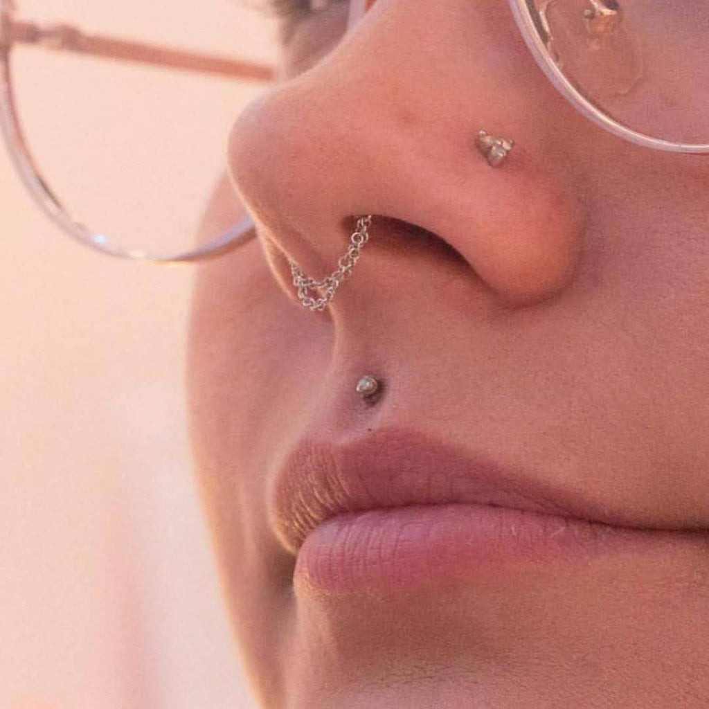 Connected Piercings: Septum to Nostril Chain Detail Connected Piercings: Septum to Nostril Chain Detail — Septum Piercing Ideas
