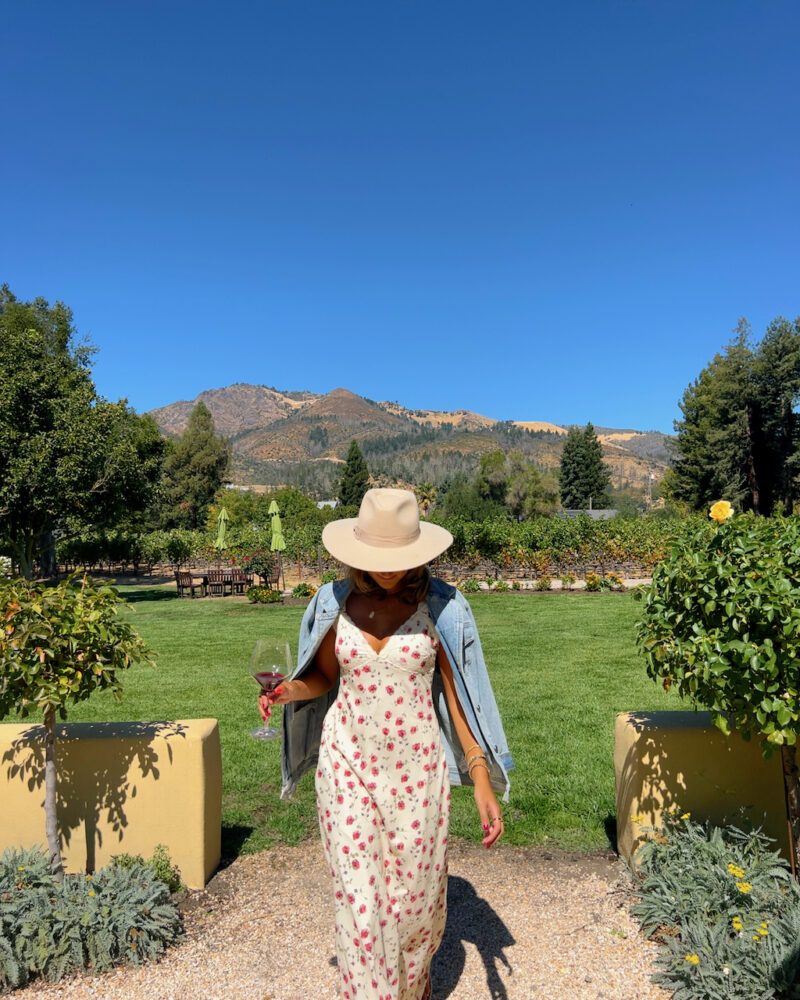 Floral Maxi Dress with Denim Jacket and Wide-Brim Hat — Winery Outfits