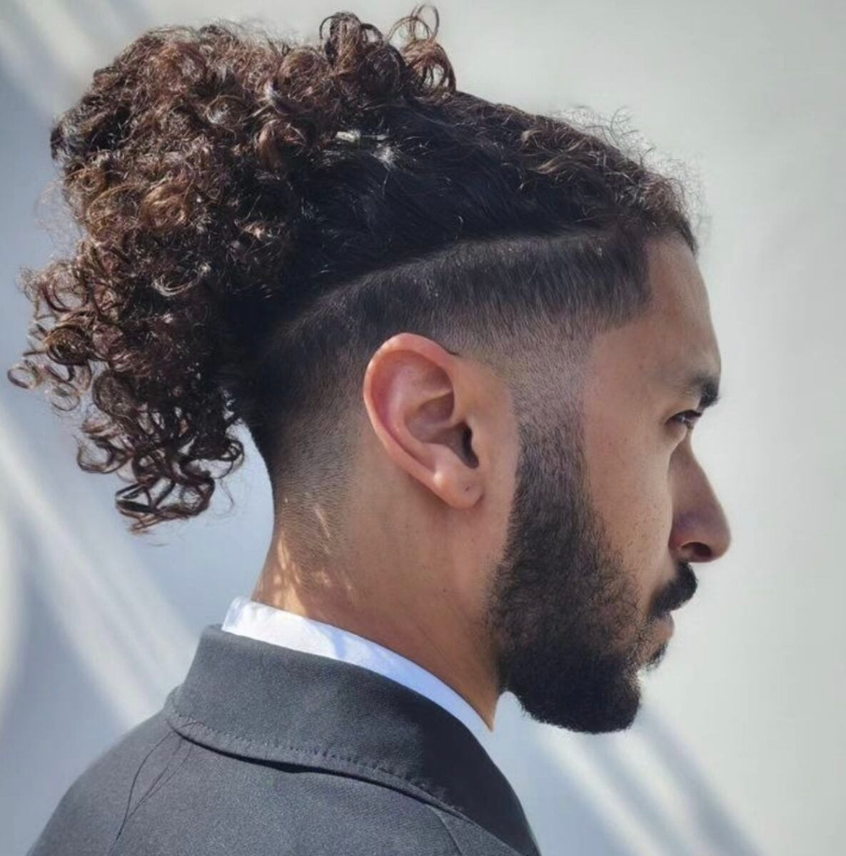 Voluminous Curly Bun Undercut — Long Hairstyles for Men