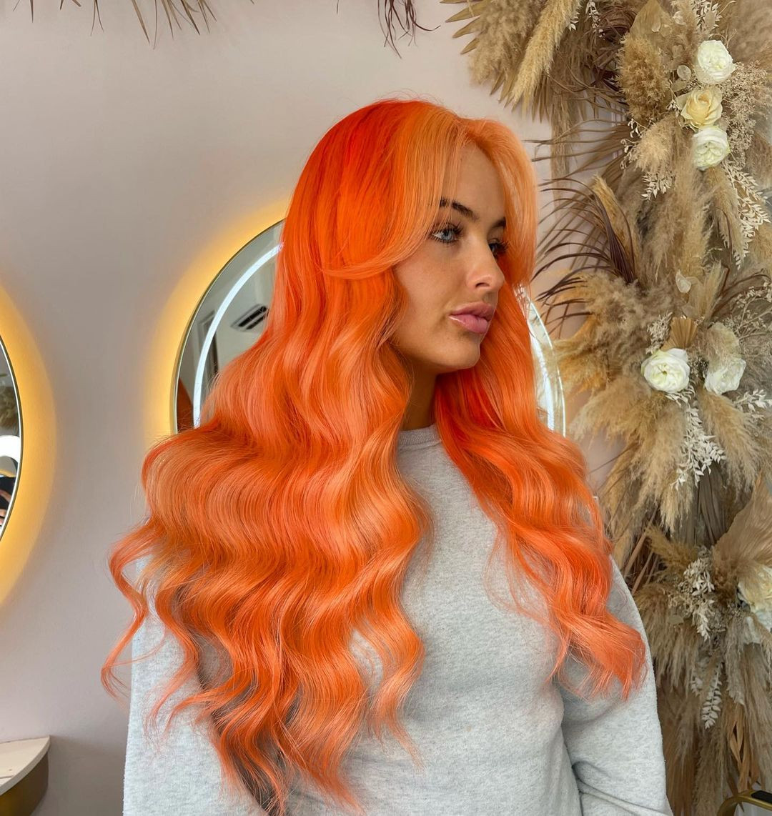 Voluminous Coral Orange Waves with Curtain Bangs — Coral Hair