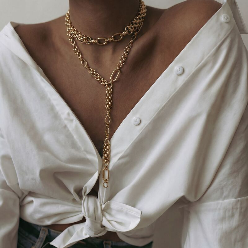 Varied Link Chunky Gold Necklaces Over White Shirt
