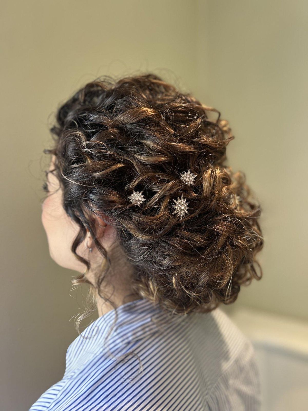 Dark Brown Low Bun With Twisted Details Dark Brown Low Bun With Twisted Details — Mother of the Bride Hairstyles