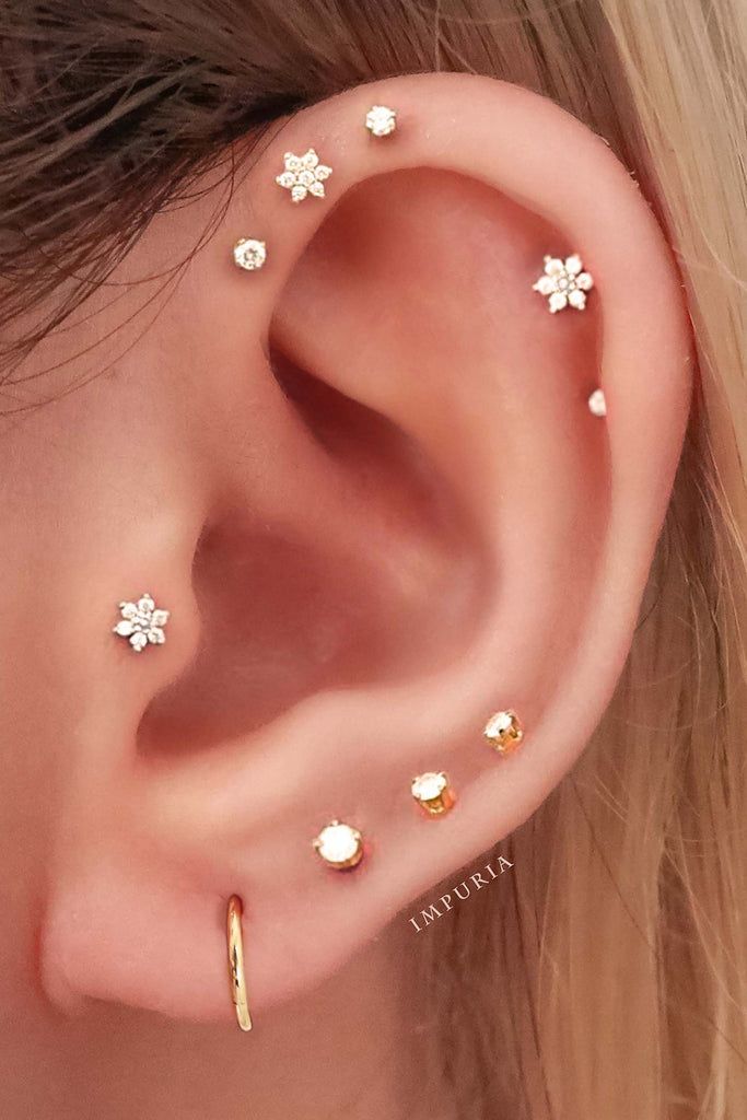 Feminine Gold Earring Stack with Flower Studs Feminine Gold Earring Stack with Flower Studs — Ear Piercing Ideas