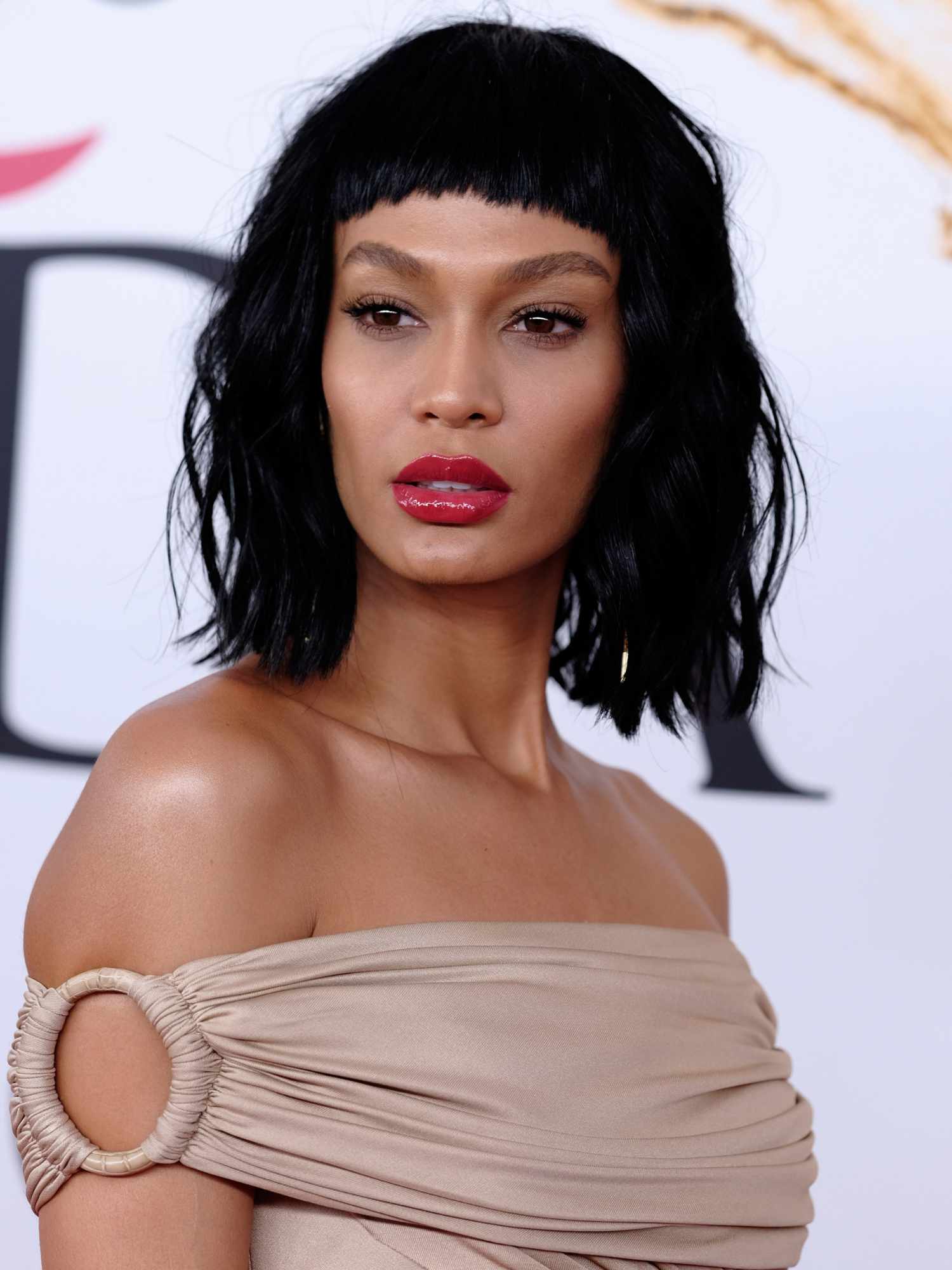 Model with Micro Bangs and an Off-the-Shoulder Beige Dress — Short Bangs