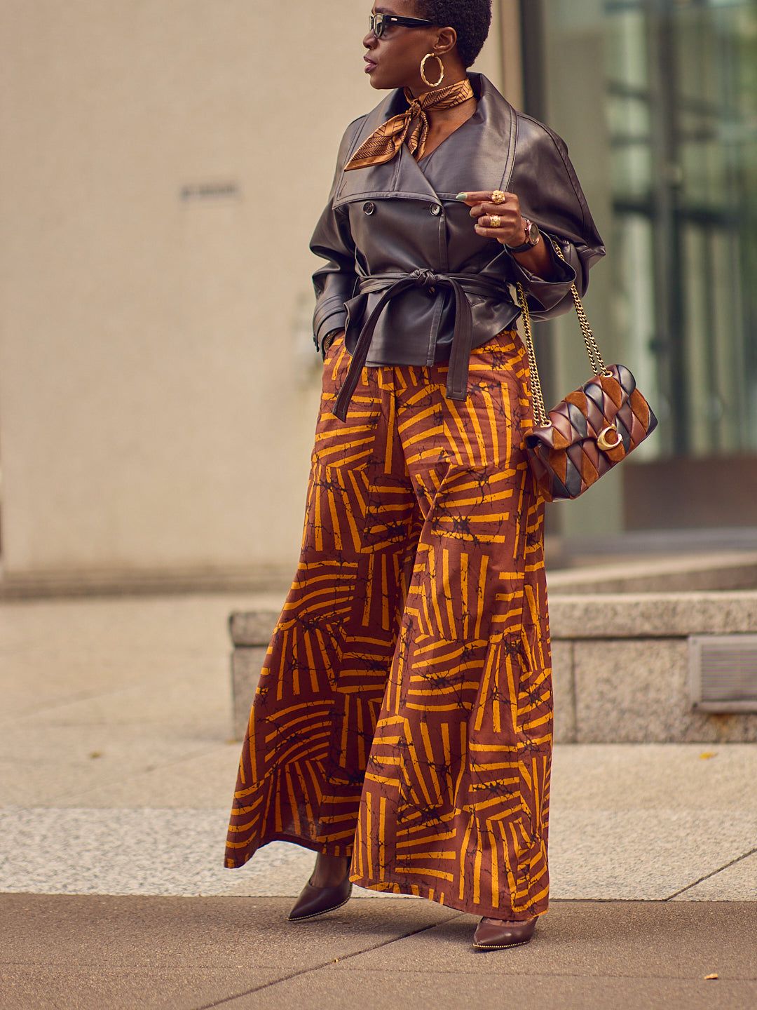 Edgy Leather Jacket with Bold Patterned Pants Edgy Leather Jacket with Bold Patterned Pants — Coach Bag Outfits