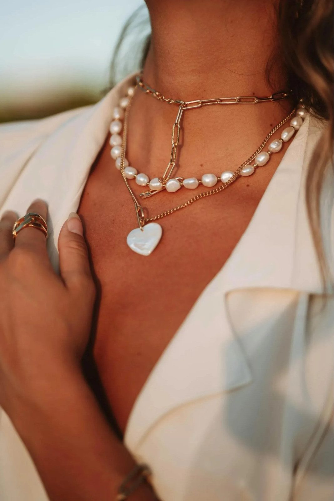 Pearl and Heart Pendant Layered Over a White Blazer Pearl and Heart Pendant Layered Over a White Blazer — Pearl Necklace Outfits