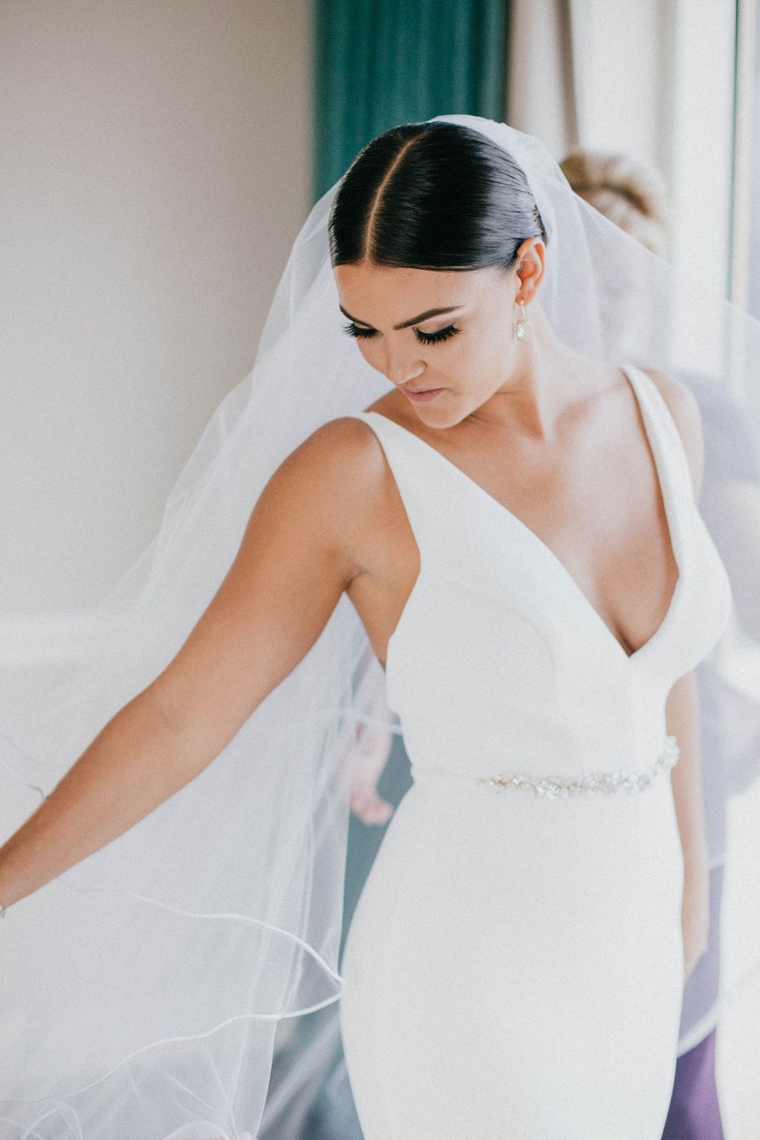 Dark Brown Sleek Bun With Side-Swept Bangs Dark Brown Sleek Bun With Side-Swept Bangs — Sleek Bun Wedding Hair