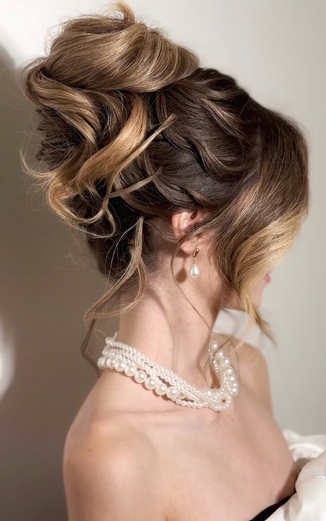 Romantic Textured Braided High Bun Wedding Hairstyle with Soft Tendrils