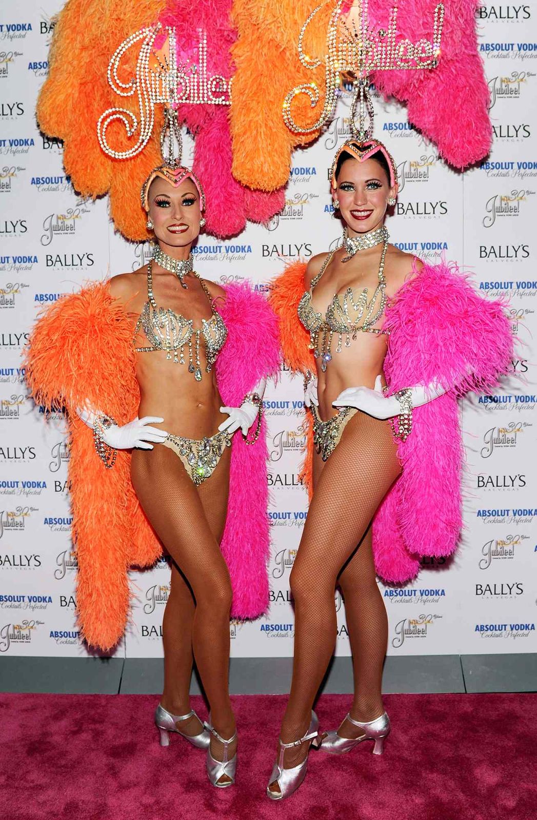 Feather Boa Drama: Vibrant Bikini Tops and Ornate Headdresses Feather Boa Drama: Vibrant Bikini Tops and Ornate Headdresses — Vegas Show Outfits