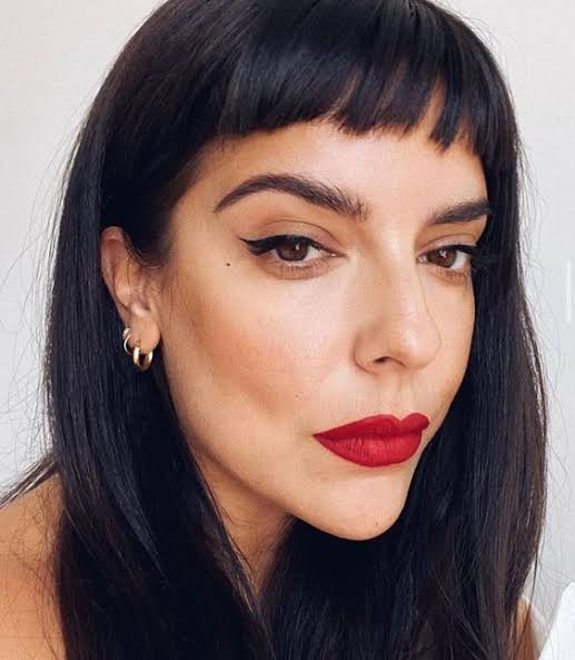Close-Up Portrait with Bold Red Lipstick and Baby Bangs Close-Up Portrait with Bold Red Lipstick and Baby Bangs