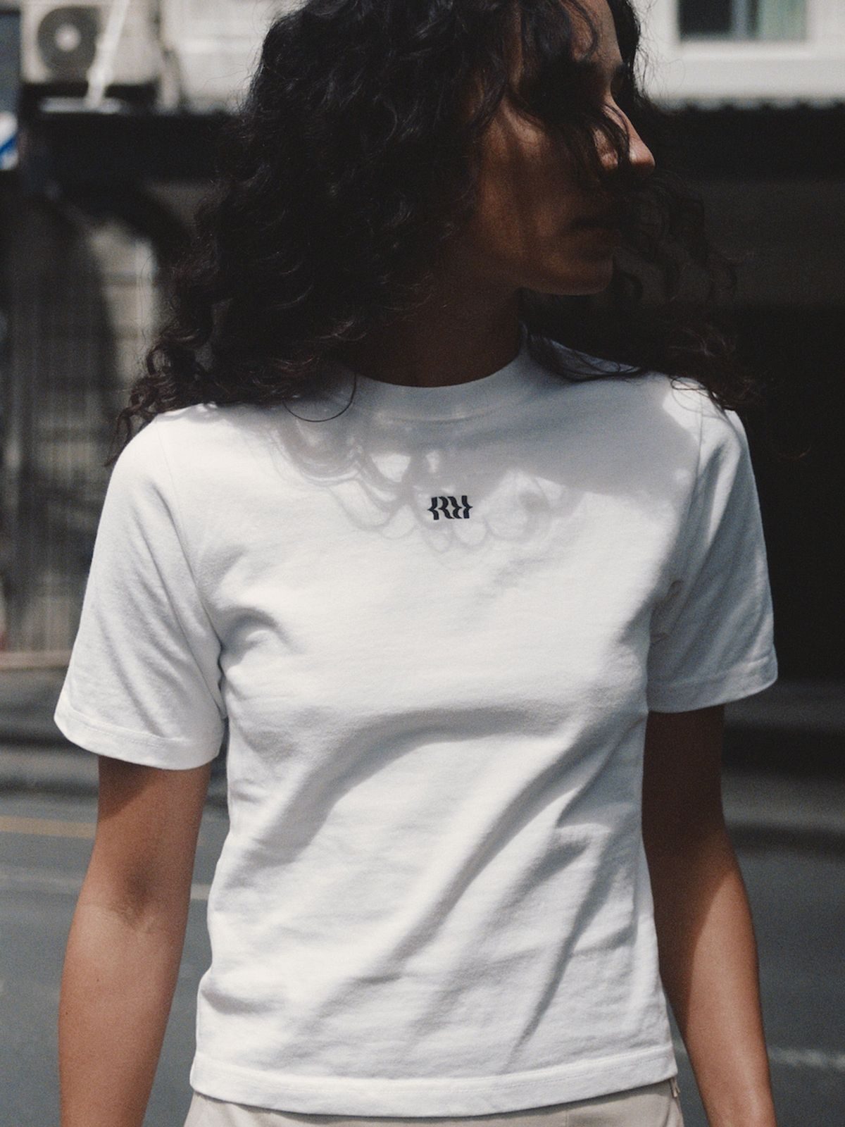Minimalist White Baby Tee with Small Black Logo Minimalist White Baby Tee with Small Black Logo — Baby Tee Outfits