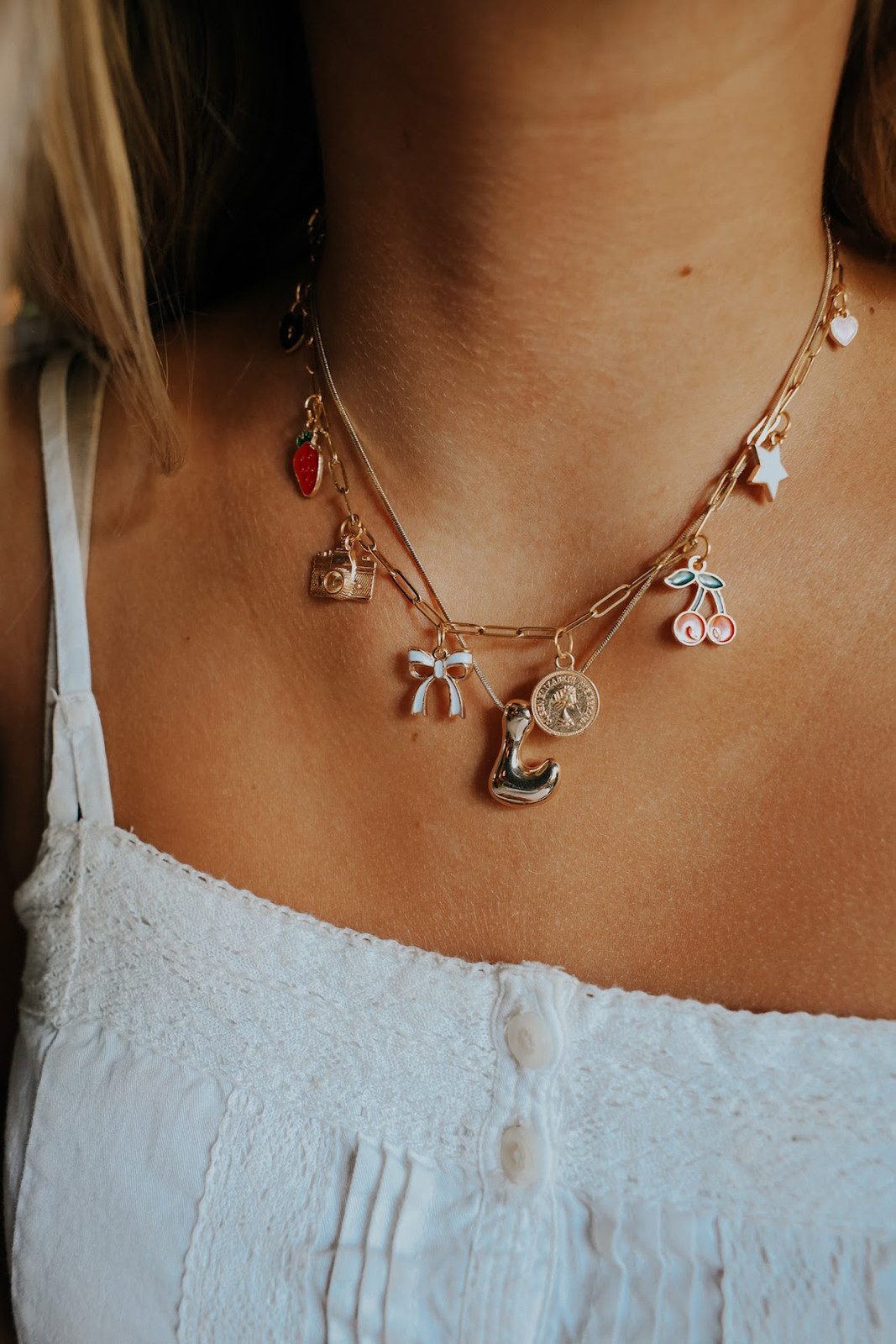 Layered Necklaces with Fruit and Bow Charms Layered Necklaces with Fruit and Bow Charms — Charm Necklaces