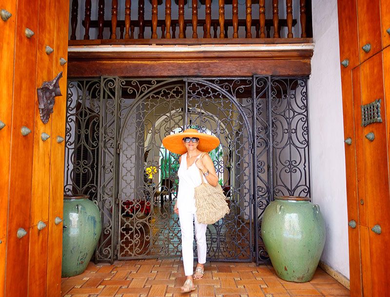 Resort Ready: All-White Linen Jumpsuit with Orange Sun Hat — Cartagena Outfits