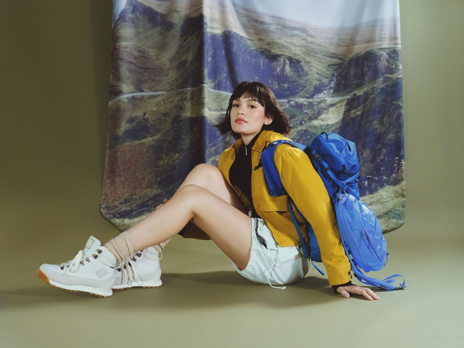 Hiking Essentials: Yellow Jacket, Blue Backpack, and White Hiking Boots — Backpack Outfits Women