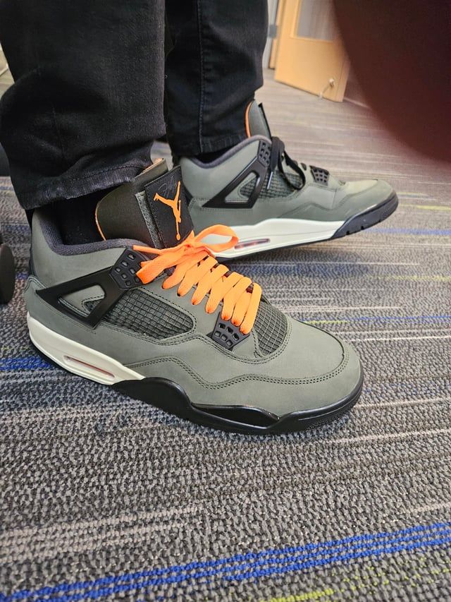 Lace Upgrade: Grey and Black Jordan 4s with Orange Laces Lace Upgrade: Grey and Black Jordan 4s with Orange Laces — Jordan 4 Outfits
