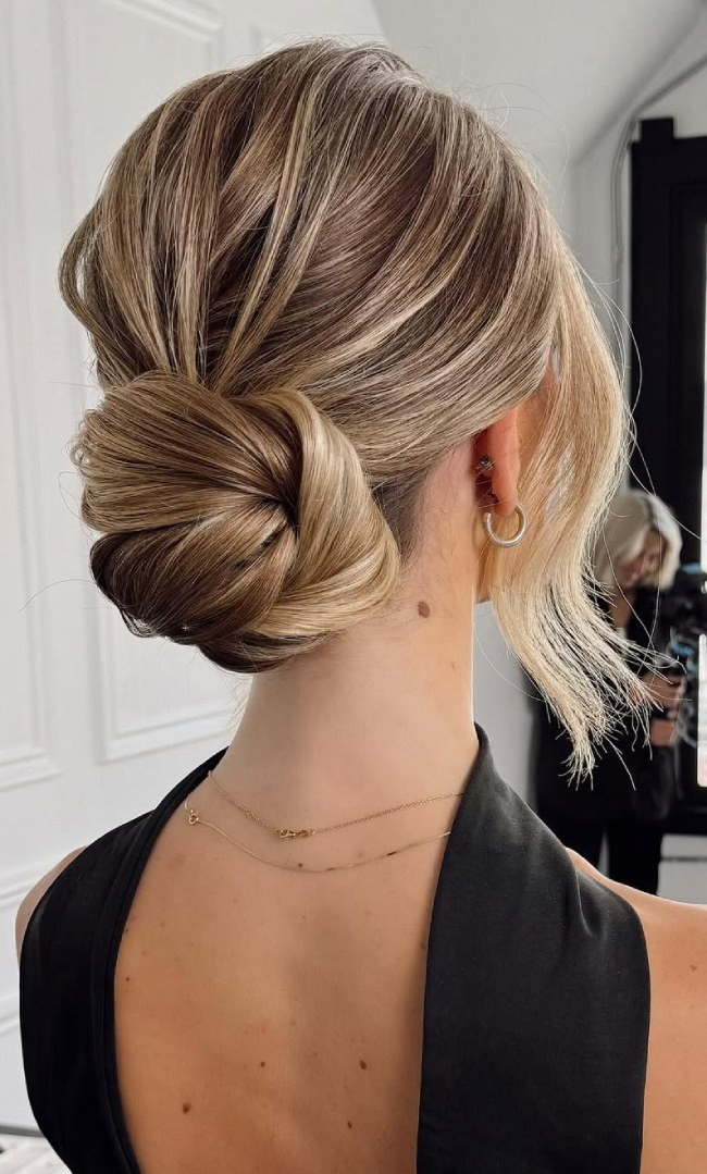 Elegant Blonde Twisted Bun Elegant Blonde Twisted Bun — Low Bun with Curtain Bangs