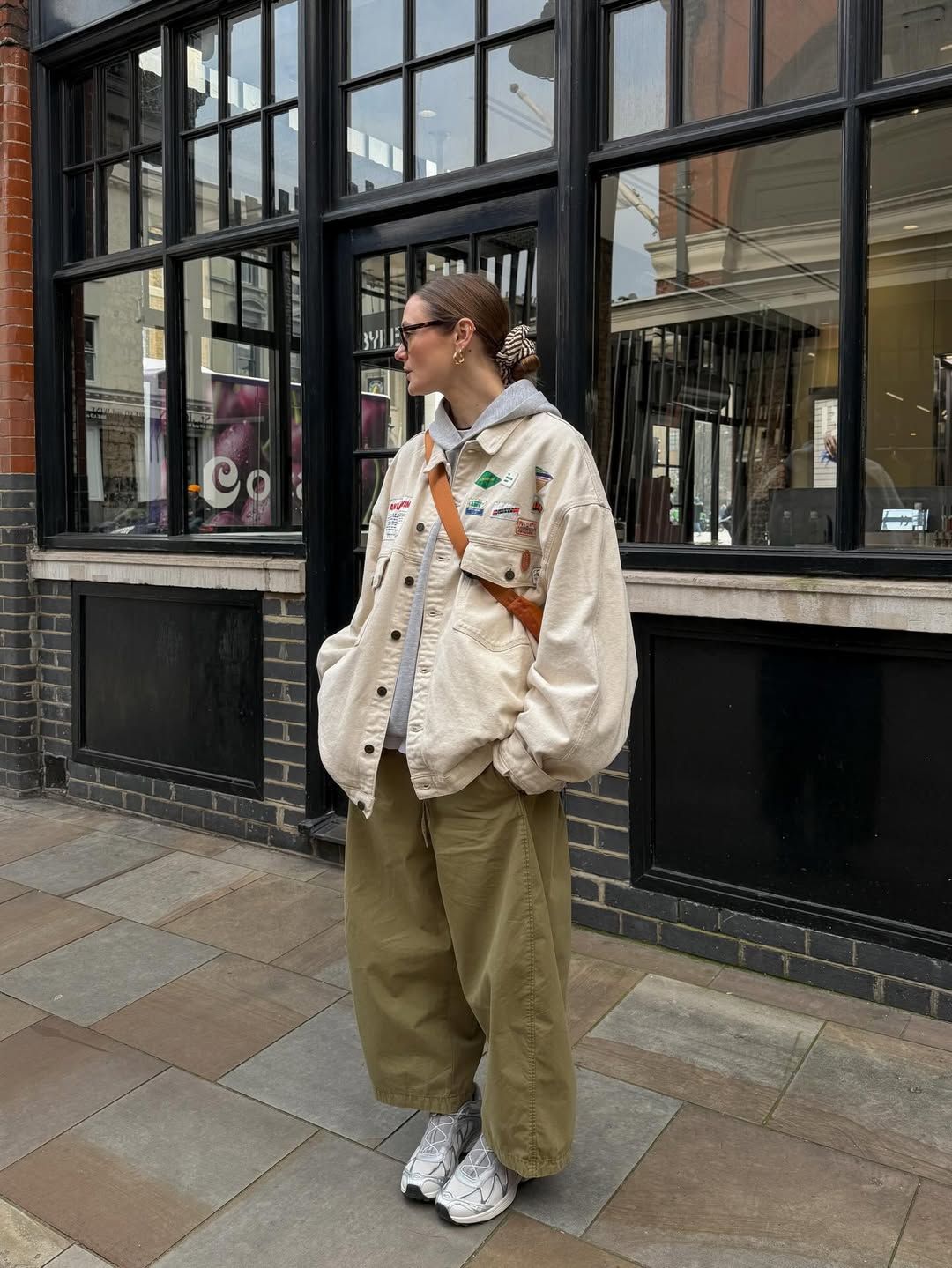 Relaxed Layers: Baggy Trousers and Patched Jacket with Grey Salomon Sneakers Relaxed Layers: Baggy Trousers and Patched Jacket with Grey Salomon Sneakers — Salomon Outfits
