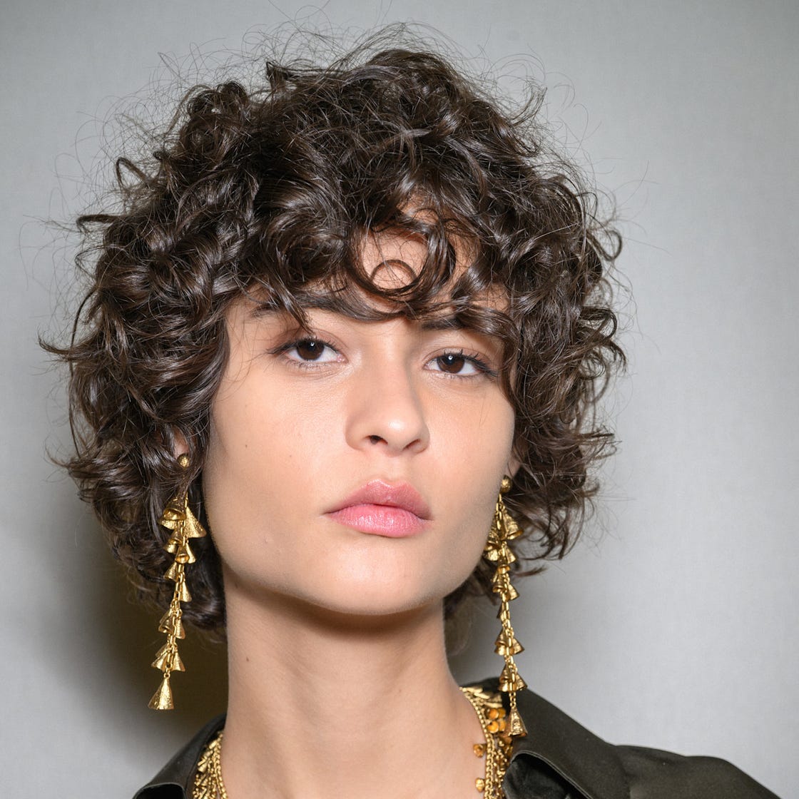 Dark Green Collared Shirt with Gold Accessories Dark Green Collared Shirt with Gold Accessories — Curly Bangs