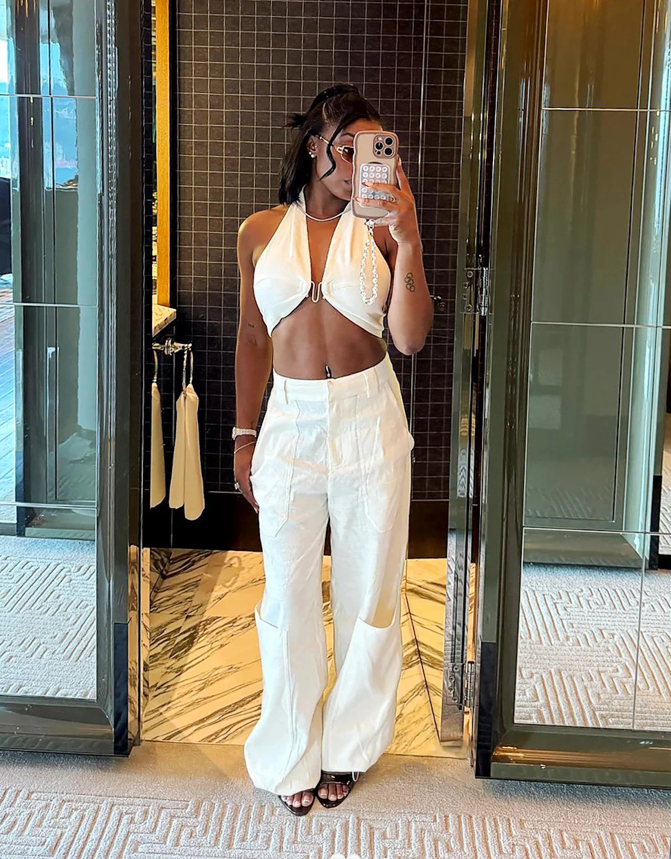 Chic Casual: White Halter Top and Wide-Leg Pants with Belly Piercing — Belly Button Piercing Ideas