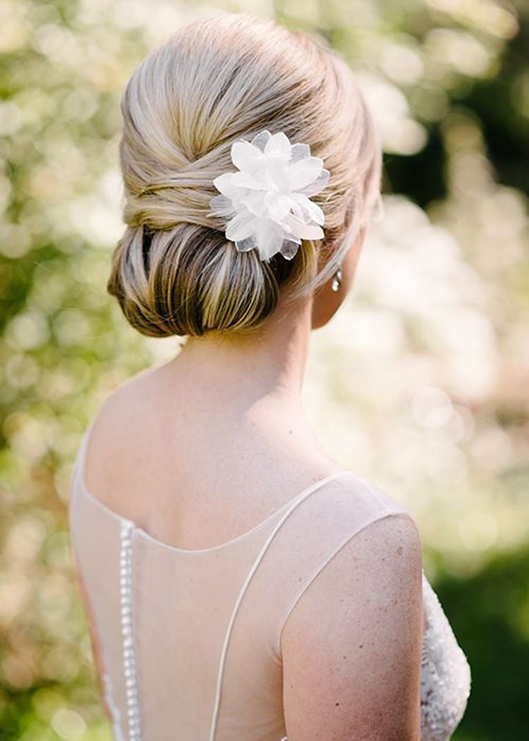 Smooth Twisted Low Bun With Floral Pin — Wedding Updos
