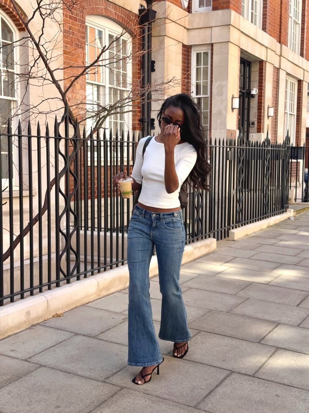 Flare Jeans, White Tee, and Black Strappy Heels for a Day Out — Heels with Jeans Outfits