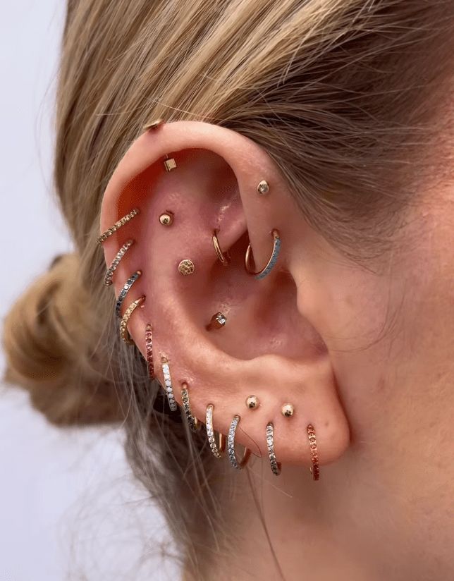 Diverse Piercing Placement in Gold, Silver, and Clear Stones Diverse Piercing Placement in Gold, Silver, and Clear Stones — Ear Piercing Ideas