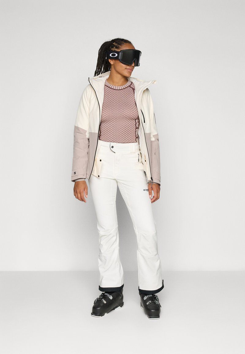 Winter Performance: Ski Suit with Patterned Knit Top and Black Ski Boots Winter Performance: Ski Suit with Patterned Knit Top and Black Ski Boots — Salomon Outfits
