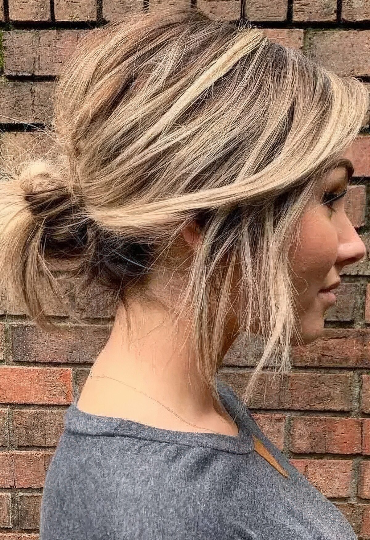 Blonde Messy Bun with Face-Framing Pieces