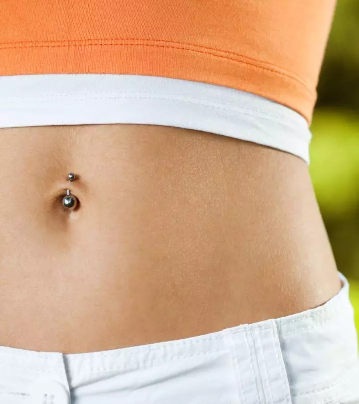 Sporty Edge: Silver Barbell Belly Piercing with Orange Crop Top — Belly Button Piercing Ideas
