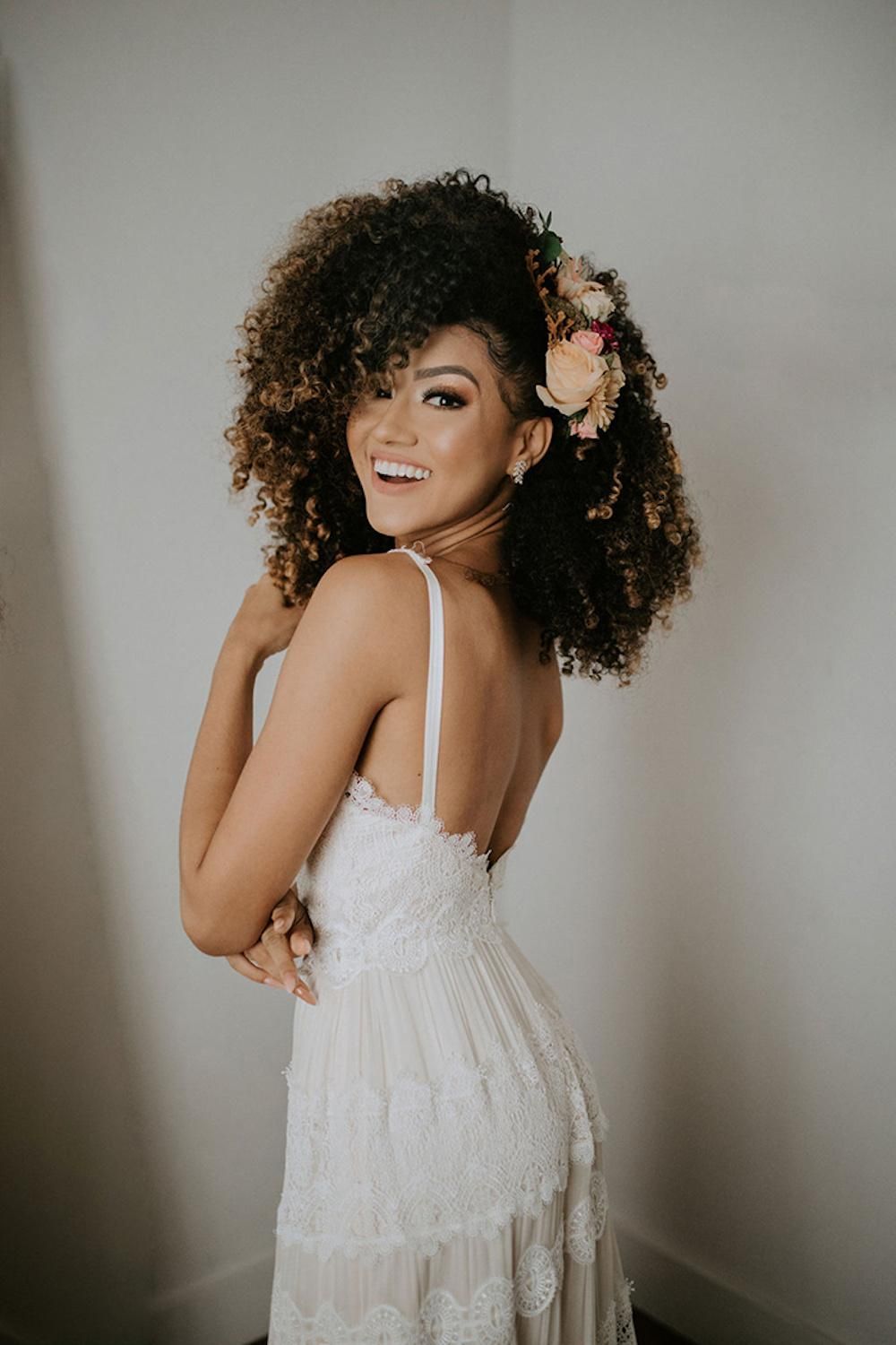 Voluminous Curls With Floral Accent Voluminous Curls With Floral Accent — Wedding Hairstyles for Black Women