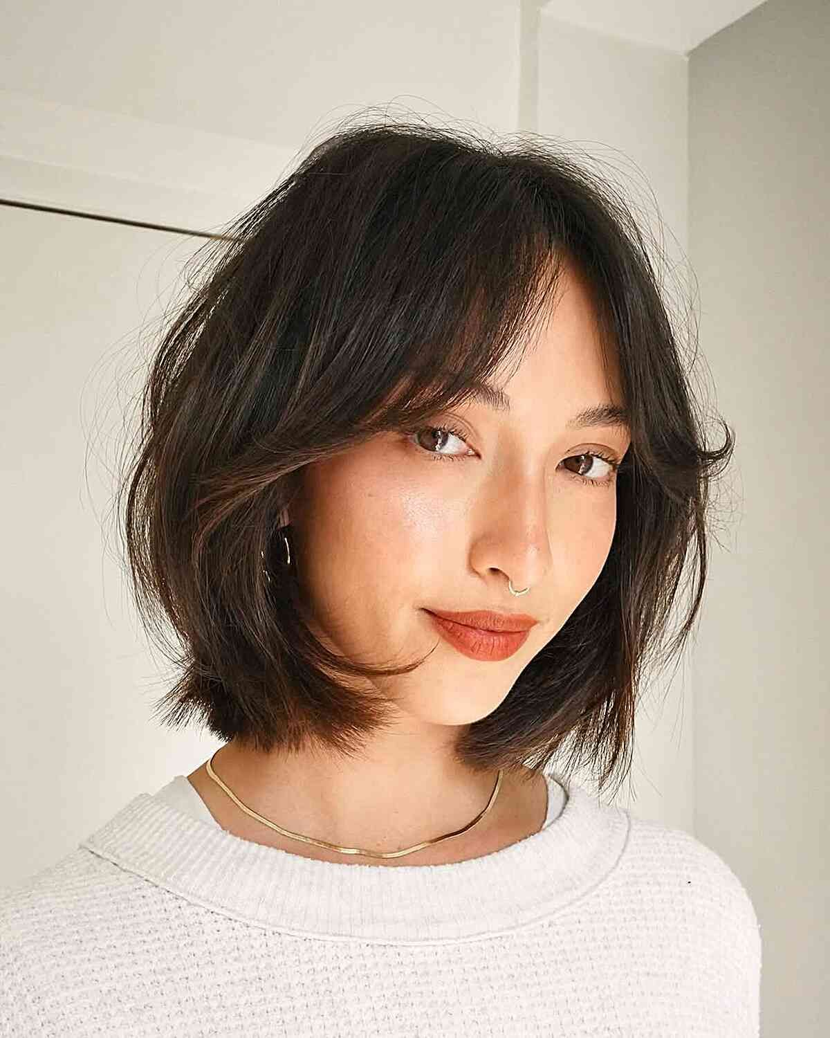Chin Textured Bob With Side-Swept Bangs — Hairstyles for Oval Faces