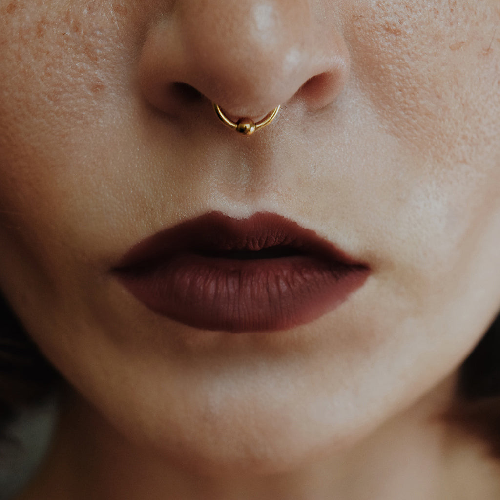 Minimalist Gold Hoop with Deep Red Lipstick Minimalist Gold Hoop with Deep Red Lipstick — Septum Piercing Ideas