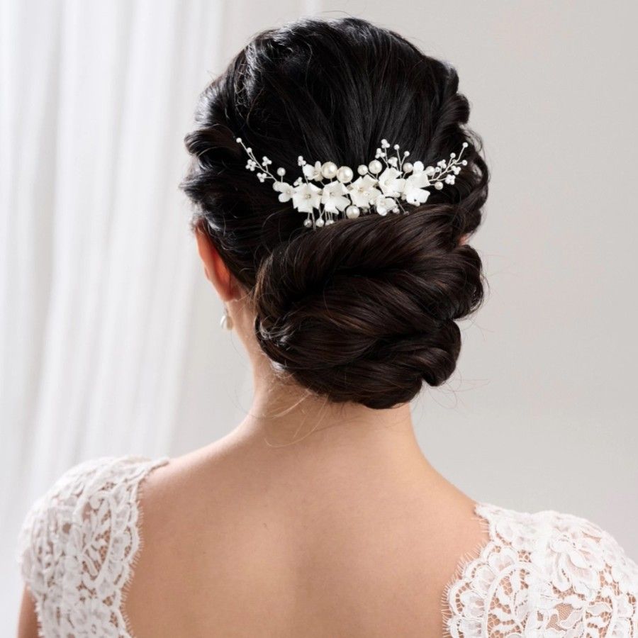 Classic Low Bun With Floral And Pearl Pin Classic Low Bun With Floral And Pearl Pin — Wedding Hairstyles for Thin Hair