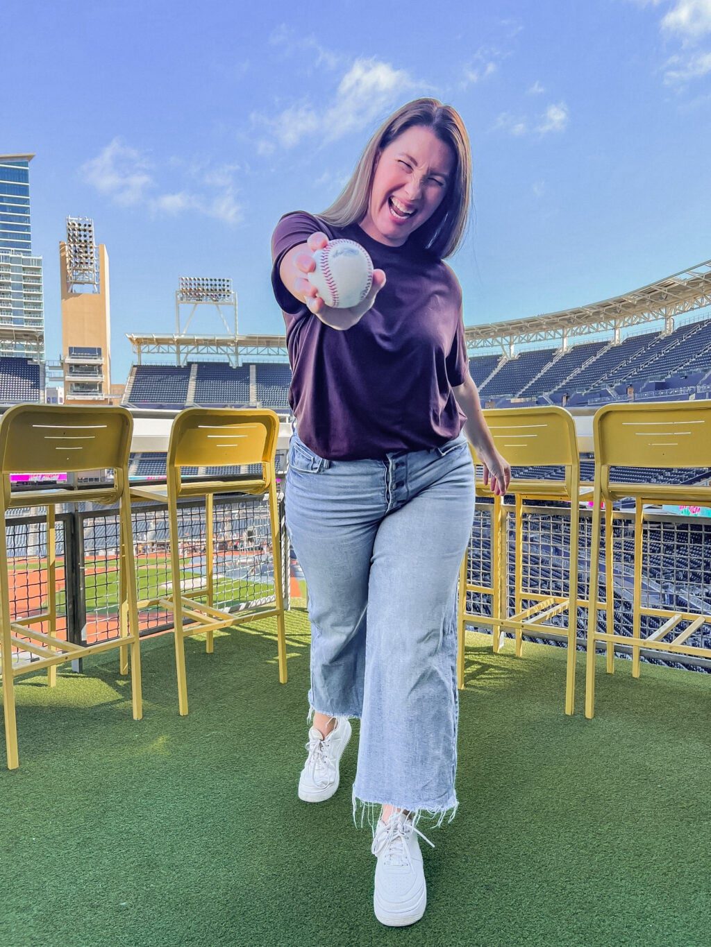T-Shirt and Straight Leg Jeans with Baseball in Hand — Baseball Game Outfits
