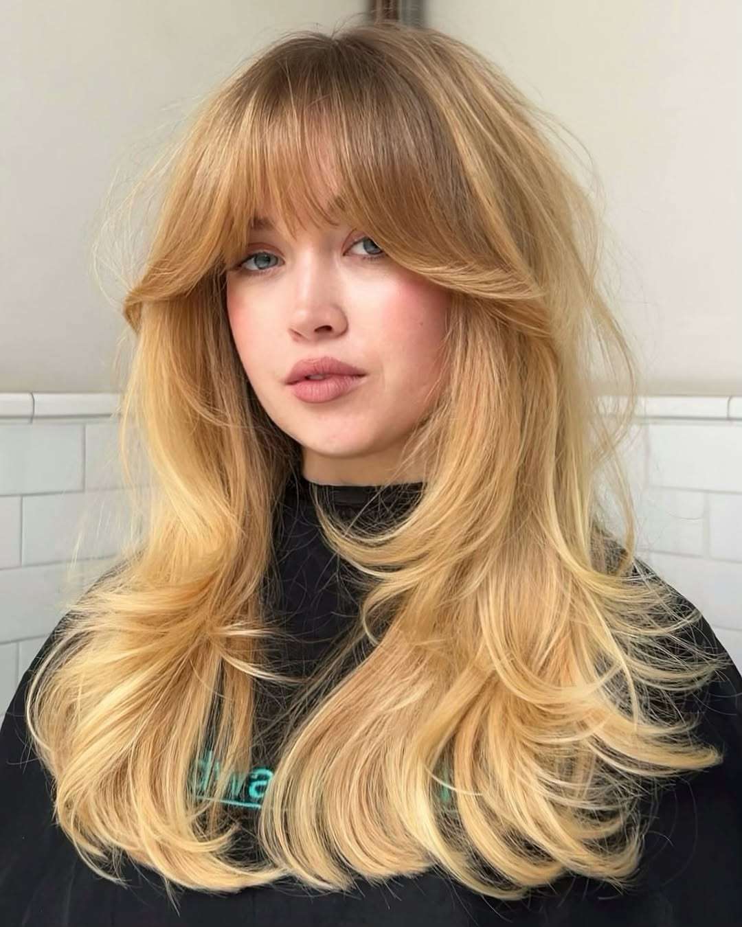 Sleek Simplicity: Black T-Shirt with Layered Blonde Hair and Bangs — Bangs with Layers