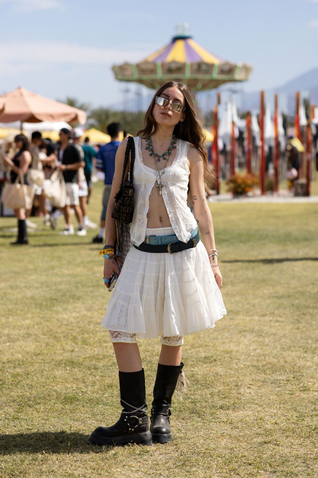 Edgy Festival Style: Black Cowboy Boots with White Mini and Sheer Top — Cowboy Boots with Skirt Outfits