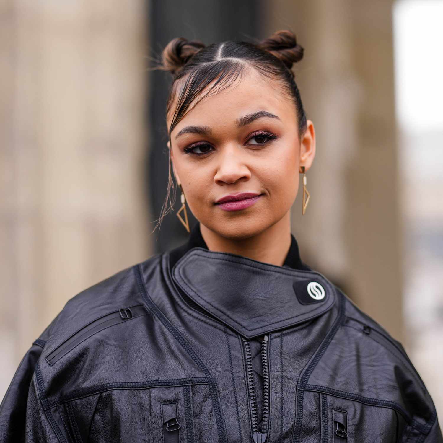 Ash Blonde Fishtail Braids Into Space Buns — Wispy Baby Bangs Frame The Face Ash Blonde Fishtail Braids Into Space Buns — Wispy Baby Bangs Frame The Face