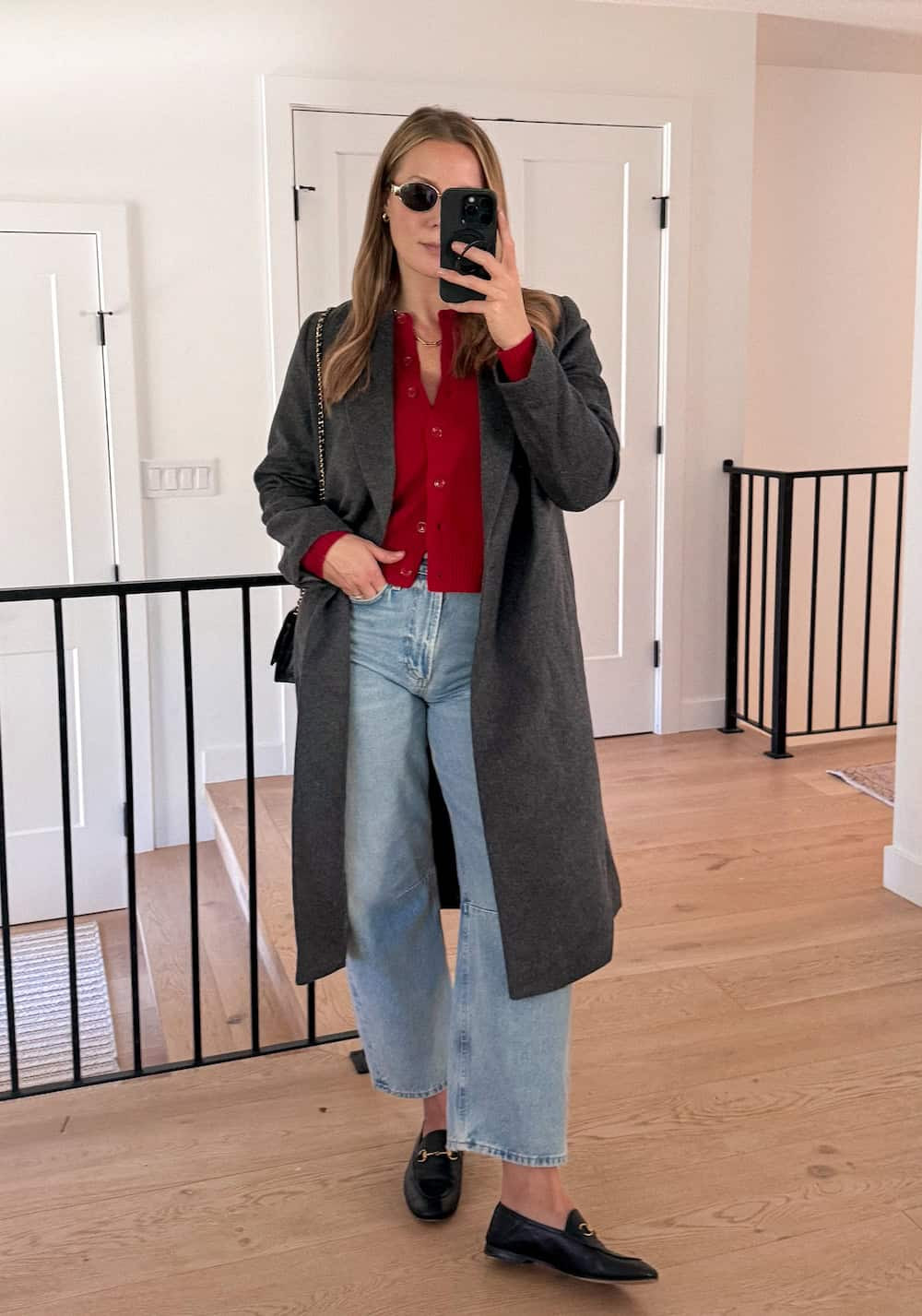 Layered Warmth: Black Horsebit Loafers with Light Wash Jeans and a Long Coat — Loafers with Jeans Outfits