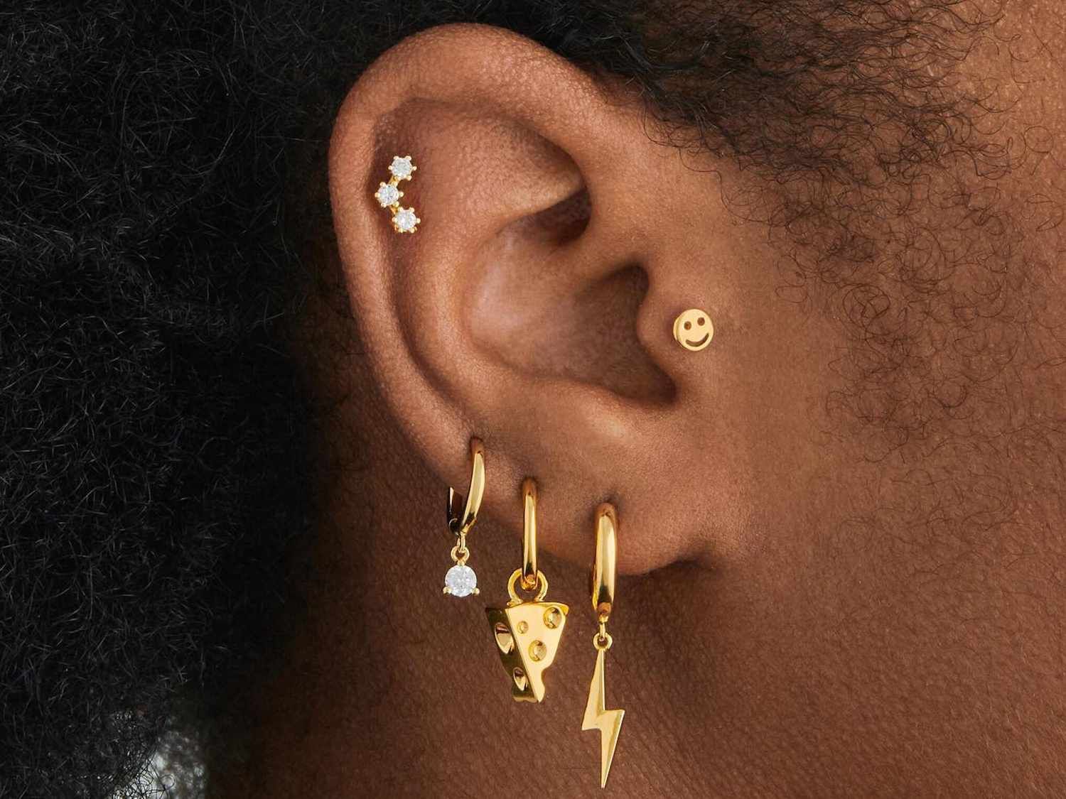 Playful Gold Piercings with Charms and Hoops Playful Gold Piercings with Charms and Hoops — Ear Piercing Ideas