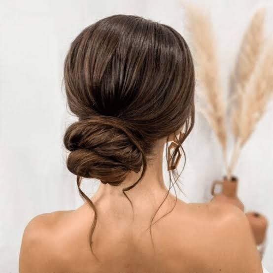 Textured Dark Brown Nape Bun With Tendrils Textured Dark Brown Nape Bun With Tendrils — Wedding Guest Hairstyles