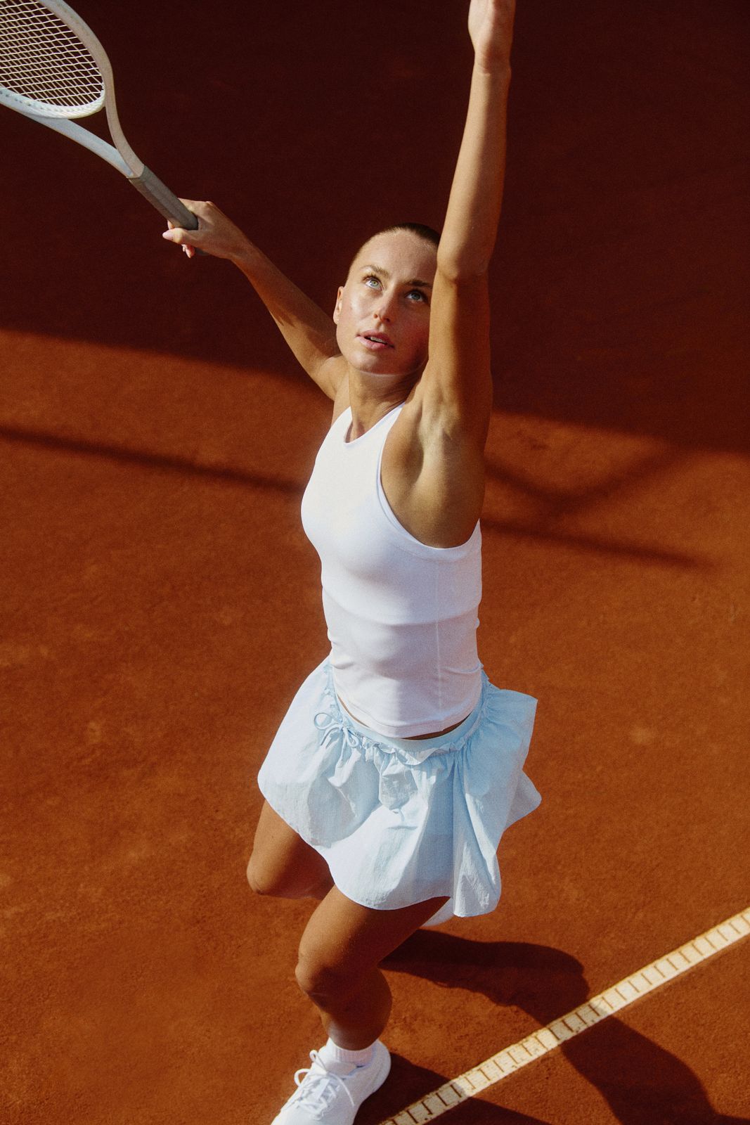 Action-Ready: Light Blue Tennis Skirt in Motion — Tennis Skirts