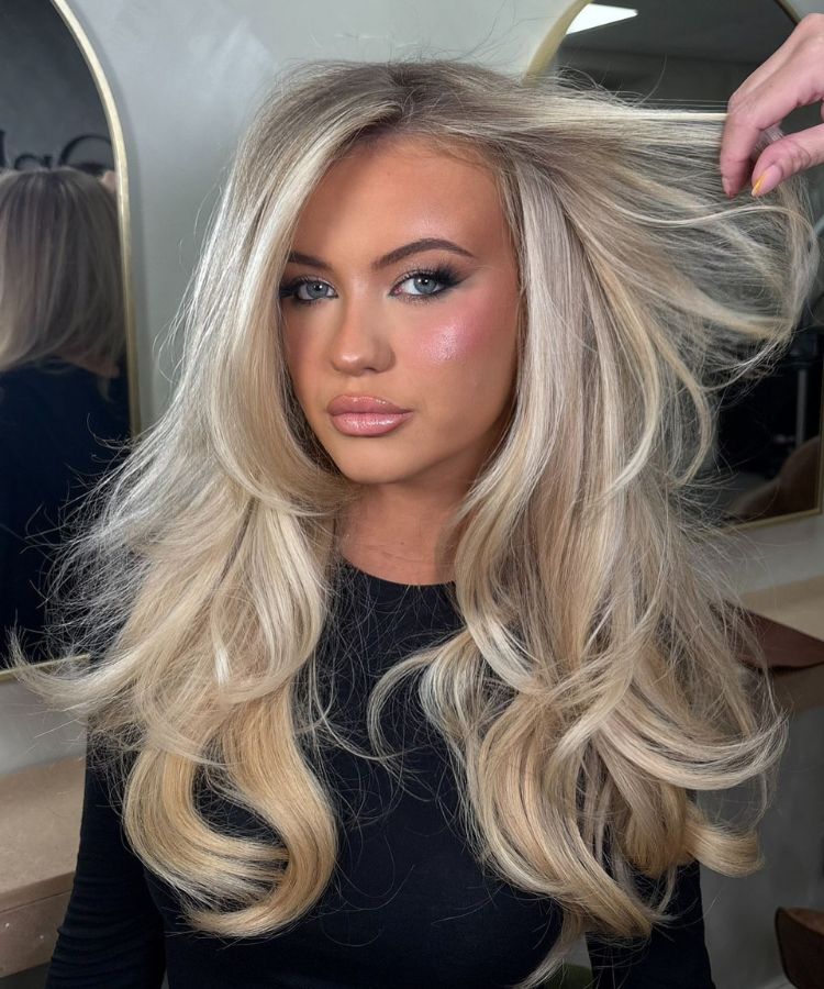 Ash Blonde Blowout With Voluminous Waves and Curtain Bangs Ash Blonde Blowout With Voluminous Waves and Curtain Bangs — Side Part Hairstyles