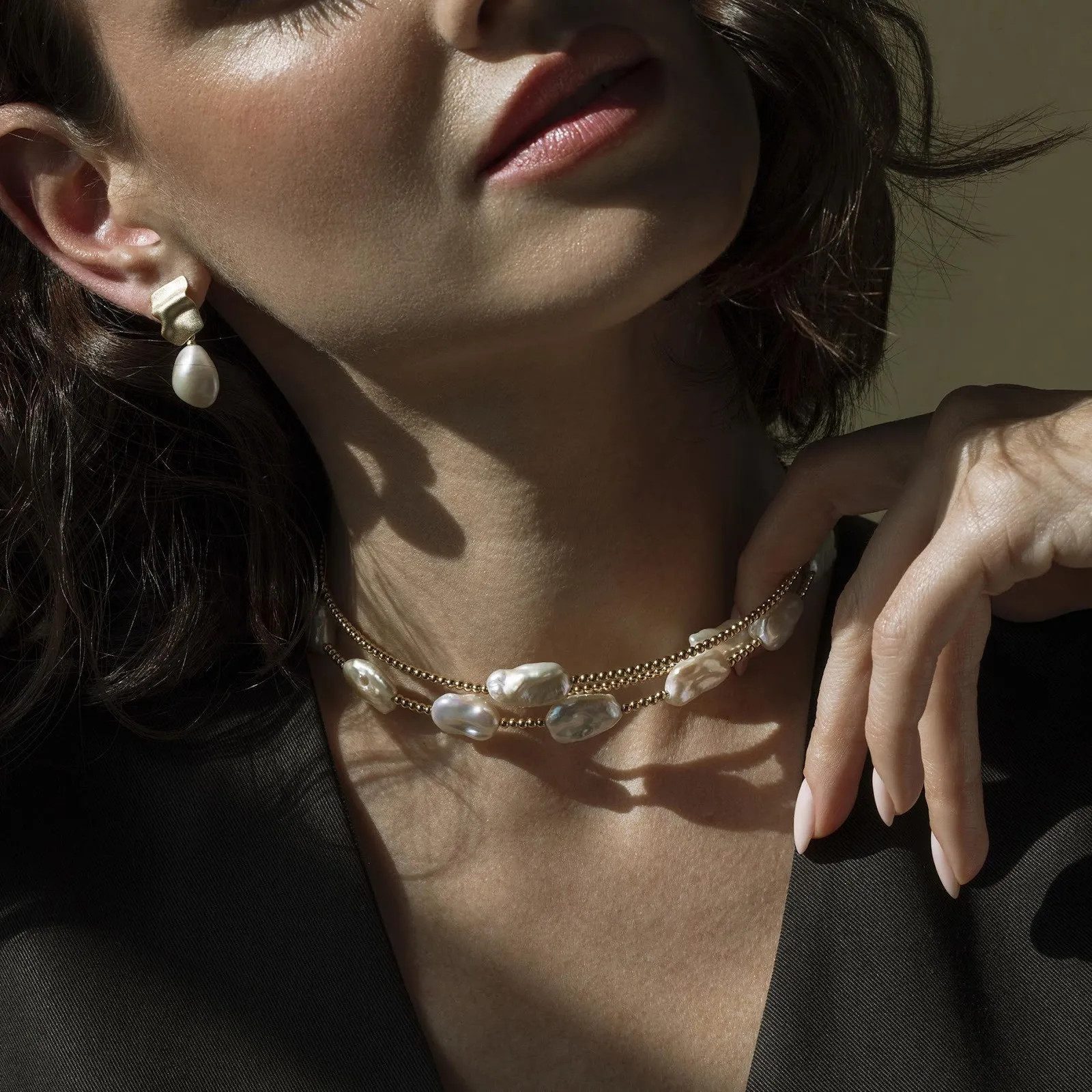 Baroque Pearl Necklace with Gold Beads Over a Dark Jacket Baroque Pearl Necklace with Gold Beads Over a Dark Jacket — Pearl Necklace Outfits