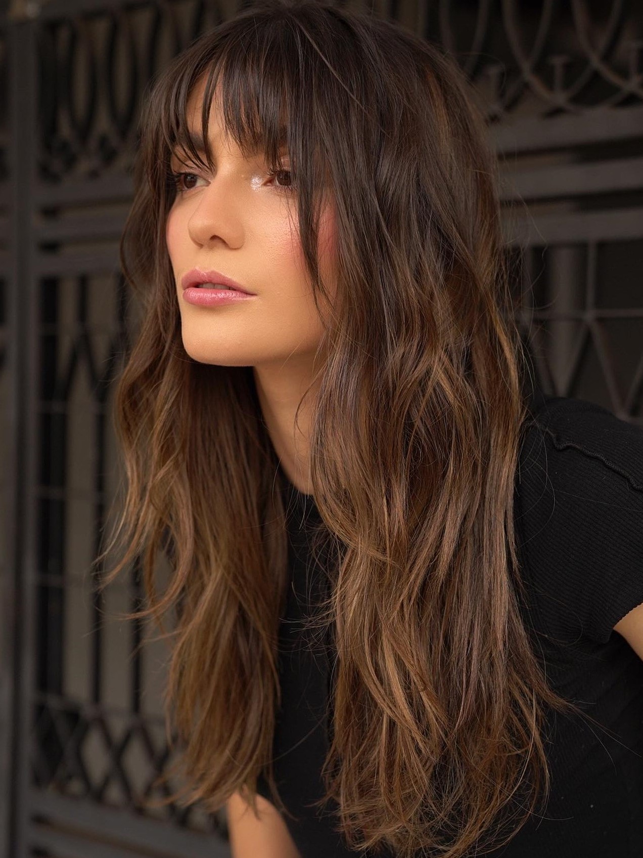Wavy Texture: Dark Brown Layered Hair with Bangs and a Black T-Shirt — Long Bangs