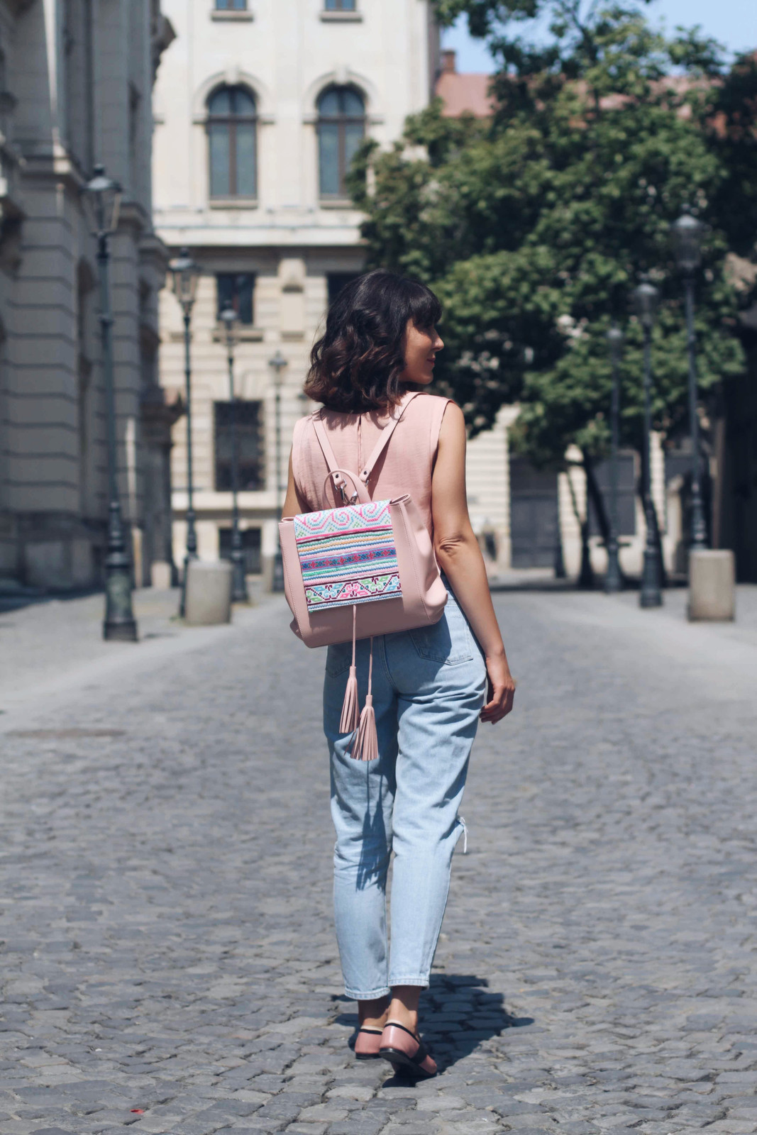 Bohemian Travel: Distressed Jeans, Embroidered Backpack, and Pink Top — Backpack Outfits Women