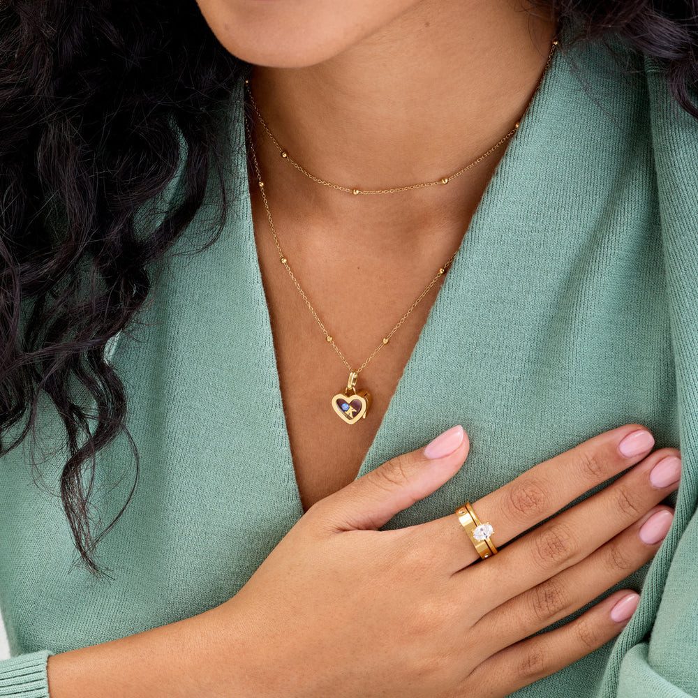 Heart Locket with Charm on Green Sweater — Locket Necklaces
