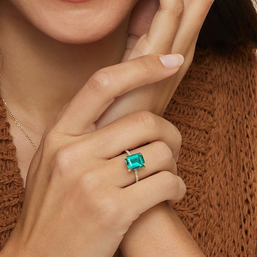 Emerald-Cut Green Gemstone Ring with Knit Sweater — Cocktail Rings