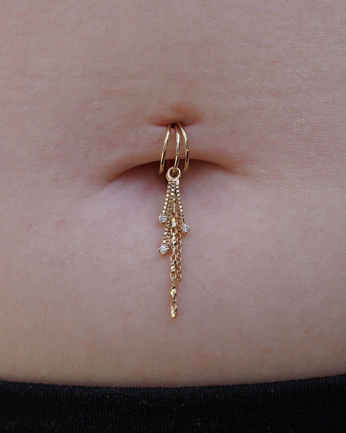 Layered Chains: Gold Belly Ring with Dangle Chains and Black Garment — Belly Button Piercing Ideas