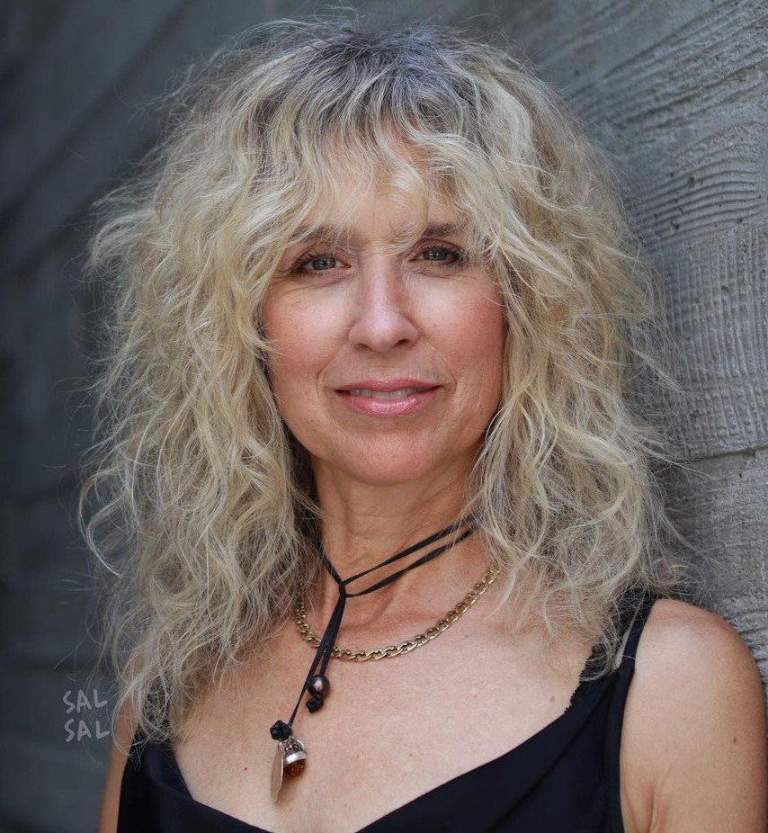 Mid-Back Platinum Shag With Grey Roots — Natural Hairstyles Over 50