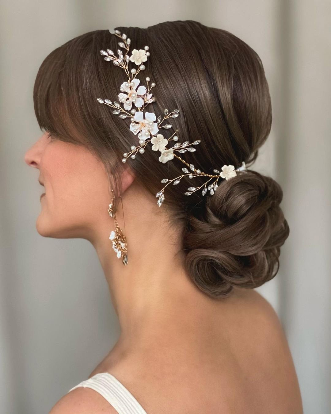 Elegant Dark Brown Textured Bun Elegant Dark Brown Textured Bun — Low Bun with Curtain Bangs
